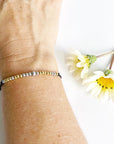 Morse Code Beaded Bracelet - Dream Big on black cord on woman's wrist