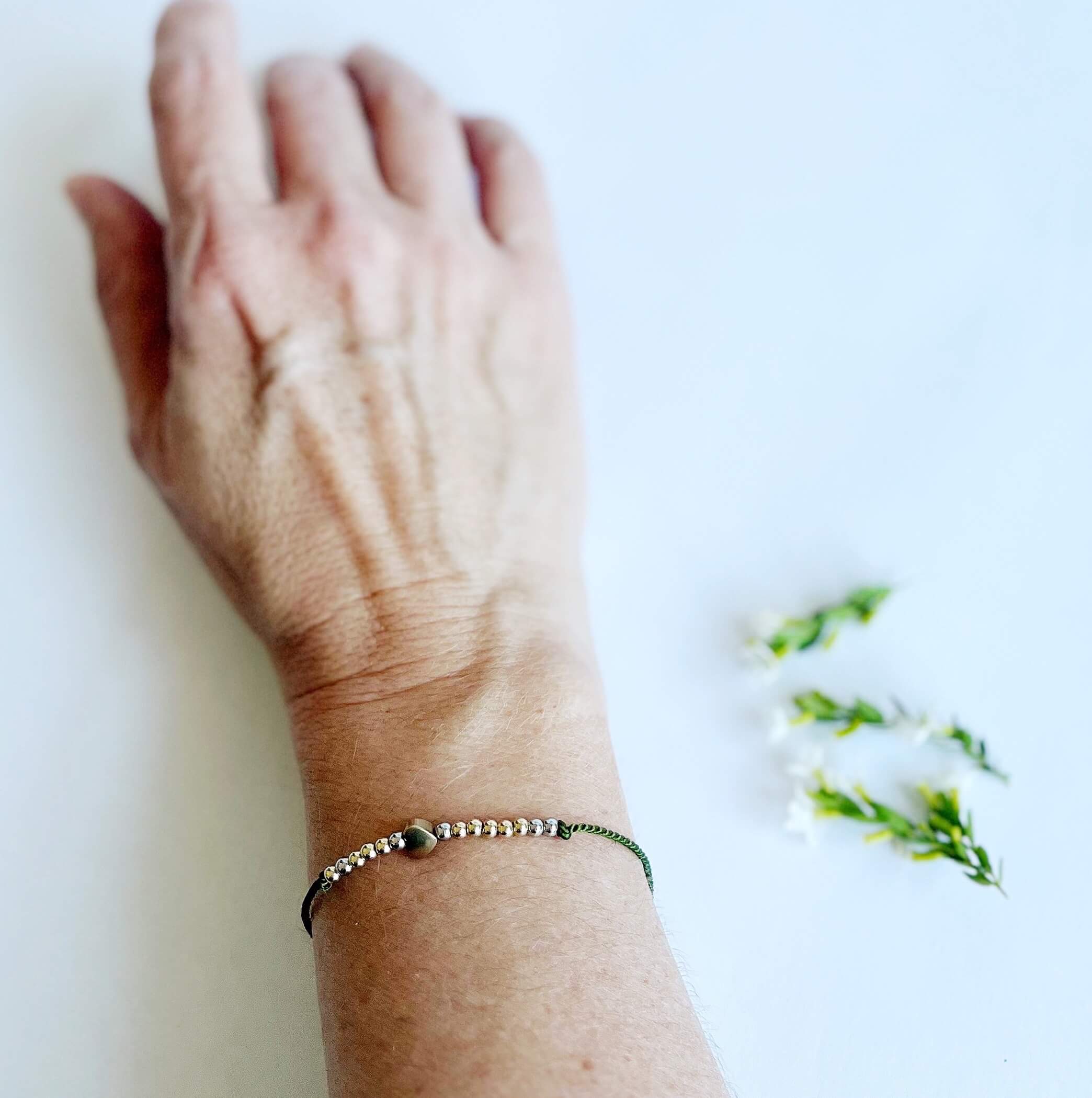 Let Them Morse Code and Charm Bracelet with a heart charm on a woman's wrist
