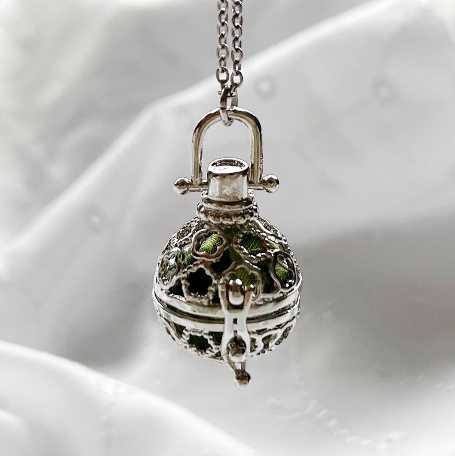 Round cage locket with green ribbon inside - Write Your Wish Locket