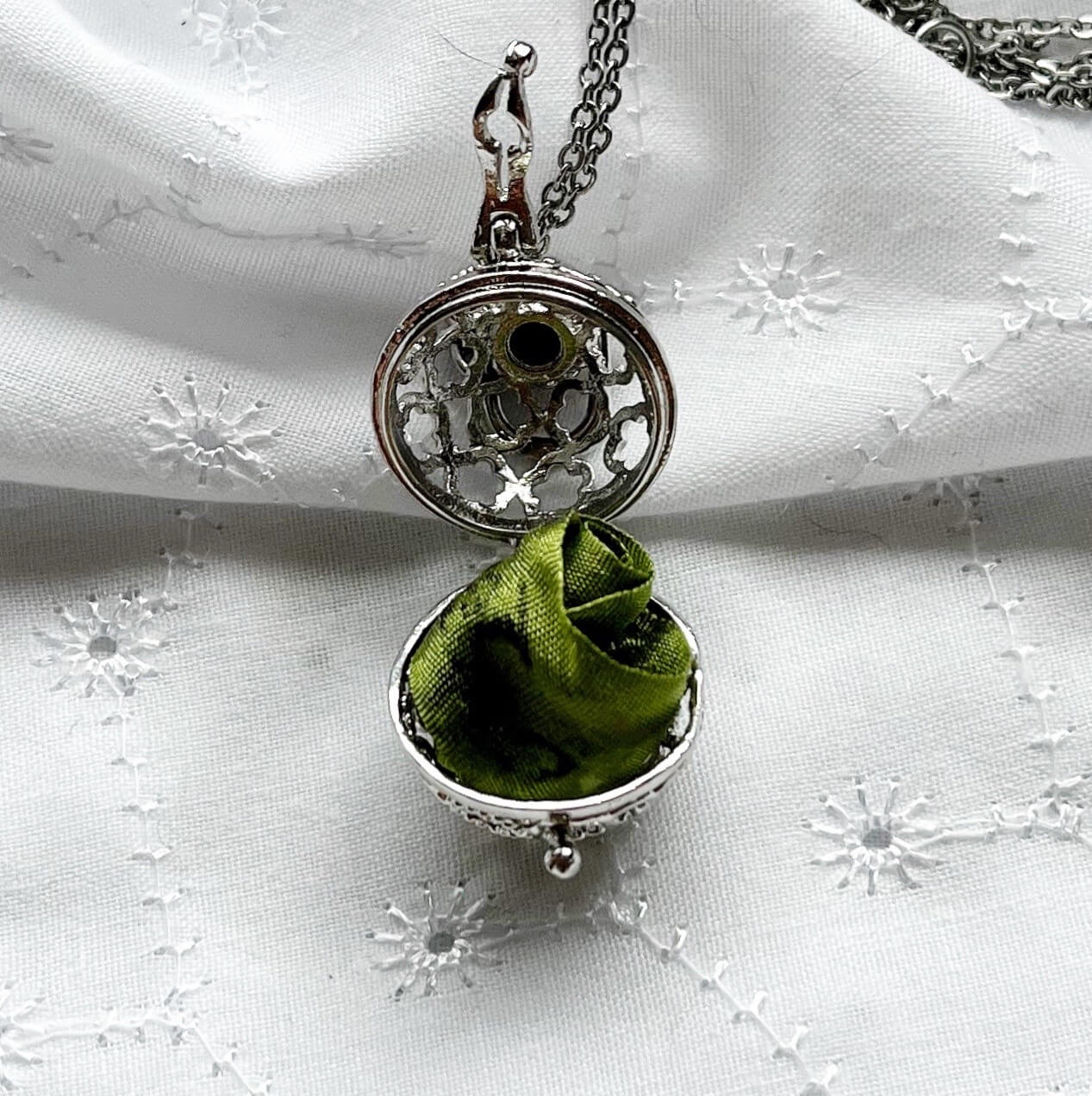 Round cage locket with green ribbon inside - Write Your Wish Necklace - locket is open to show the ribbon inside