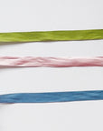 Green, pink, and blue silk ribbon