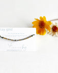 Stay Gold Morse Code Beaded Reminder Bracelet on olive cord