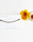 Stay Gold Morse Code Beaded Reminder Bracelet on black cord