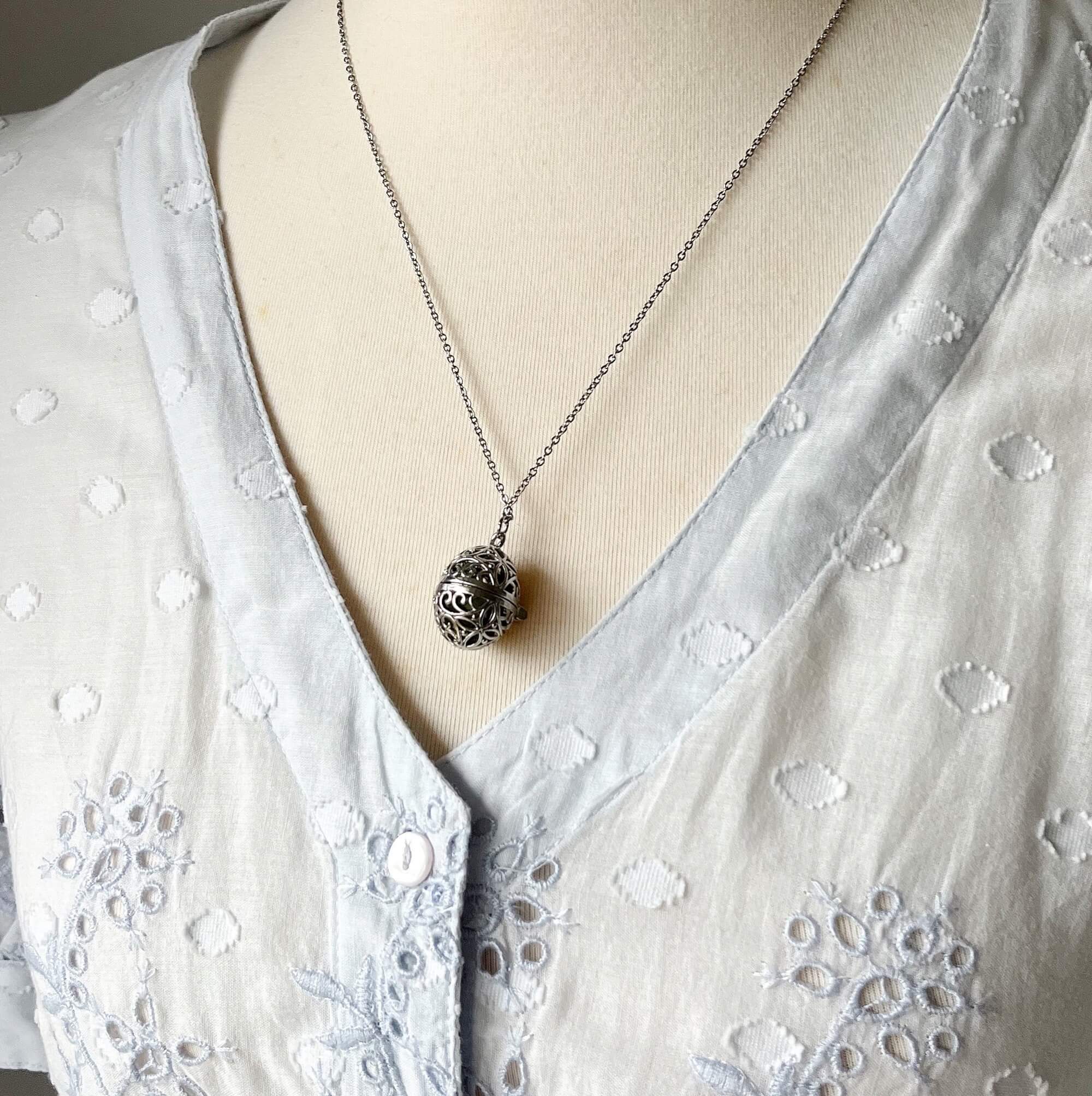 Oval cage locket with green ribbon inside - Write Your Wish Necklace - on a mannequin