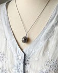 Oval cage locket with green ribbon inside - Write Your Wish Necklace - on a mannequin