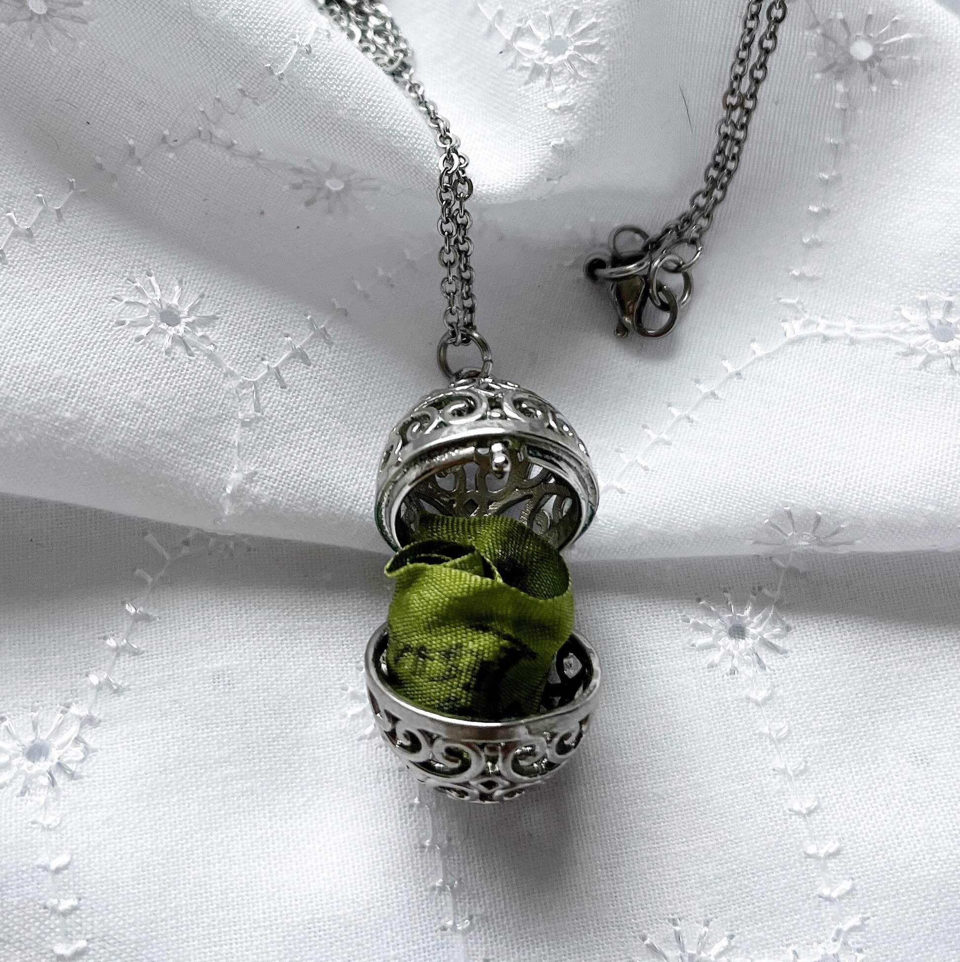 Oval cage locket with green ribbon inside - Write Your Wish Necklace - locket is open to show the ribbon inside