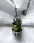 Oval cage locket with green ribbon inside - Write Your Wish Necklace - locket is open to show the ribbon inside