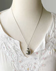 Round cage locket with green ribbon inside - Write Your Wish Necklace - on a mannequin