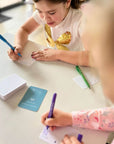 Memory Makers Your Day Edition girls filling out cards | Journal cards for families