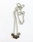 Flower charm necklace on ball chain stamped with "brave"