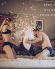 A couple having a pillow fight on a bed with the text "Step 2 Enjoy Your Date"