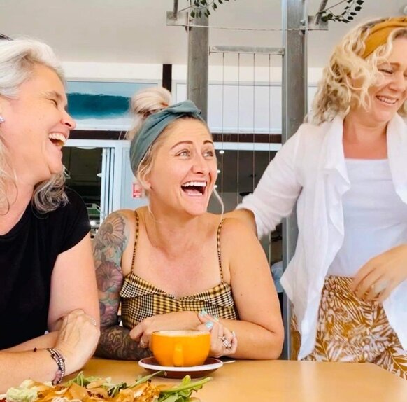 friends at a cafe laughing