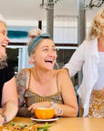 friends at a cafe laughing