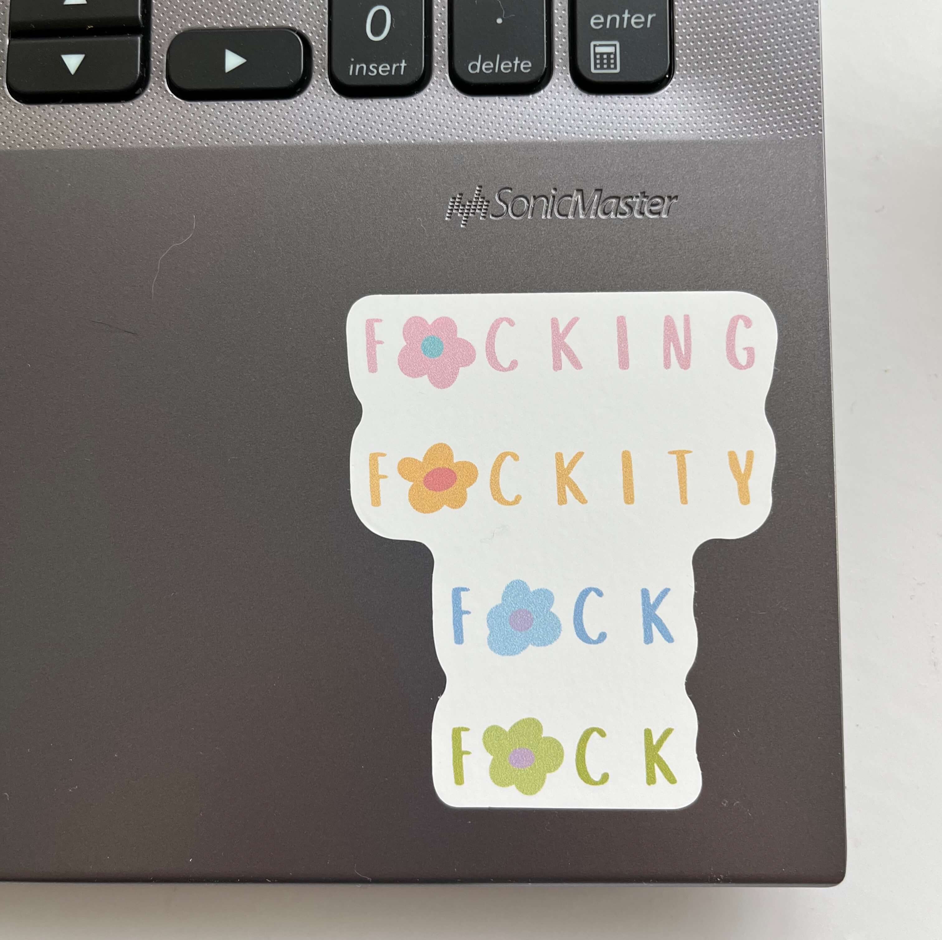 Fucking fuckity fuck fuck sticker with flowers and pastels on a laptop