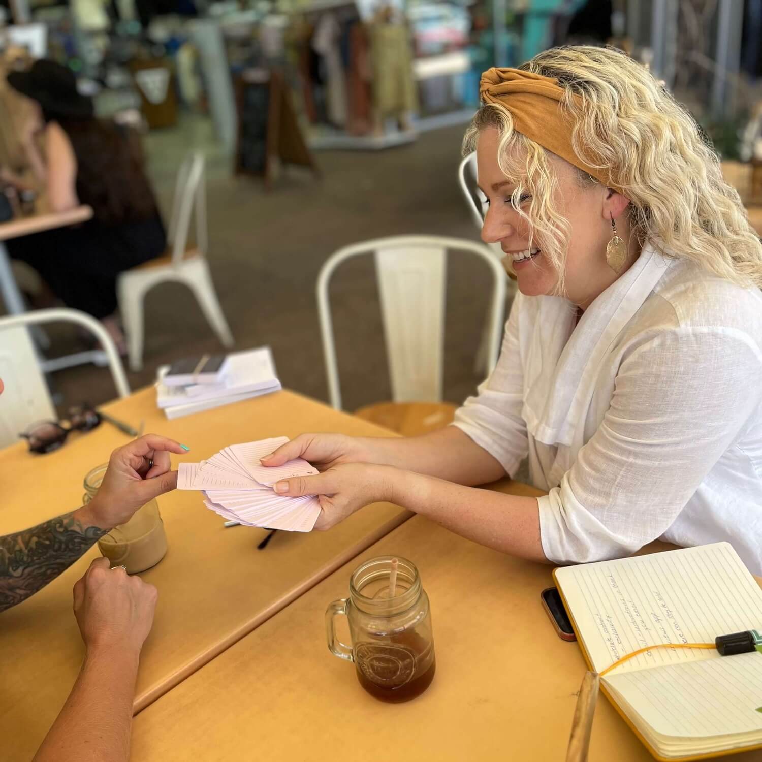 Memory Makers Sweary Self-Love Edition friends at a cafe choosing a card