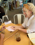 Memory Makers Sweary Self-Love Edition friends at a cafe choosing a card