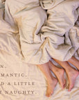 a couple in bed, just their feet showing under the blankets with the text fun. Romantic. And a little bit naughty. 